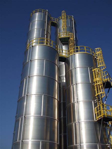 Custom Fiberglass Ladders with Cages and rest platforms on Stainless Storage Tanks